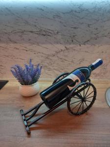 a bottle of wine in a cart on a table at Moon apartment in Mostar