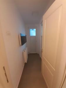 an empty hallway with a door and a window at Pensiunea Albert in Hîrşova +29 photos