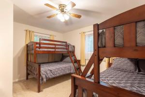 a bedroom with two bunk beds and a ceiling fan at Cozy Poconos Ranch Home with Pool Access, Near Lake! in Gouldsboro +33 photos