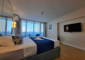 Ένα ή περισσότερα κρεβάτια σε δωμάτιο στο Aparthotel Orbi City sea view
