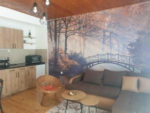 a living room with a couch and a painting on the wall at Apartman_trile in Ulcinj