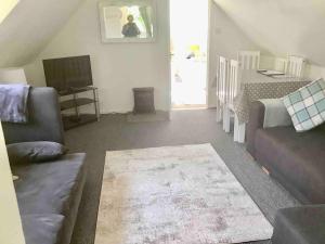 un soggiorno con divano e TV di Self Catering Apartment, Jurassic Coast/Dorset a Wareham