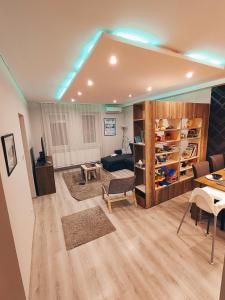a living room with a couch and a table at Family Residence in Eger