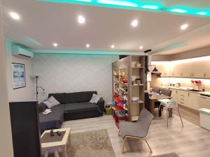 a living room with a couch and a kitchen at Family Residence in Eger