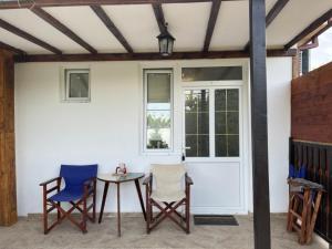 a patio with two chairs and a table and a door at Villa Vesna in Veles