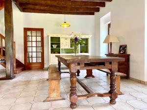 - une salle à manger avec une table en bois dans l'établissement Gîte de charme au cœur de la campagne bretonne, à Noyal-sur-Vilaine