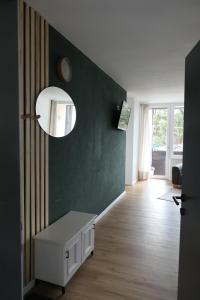 a living room with a table and a mirror at NEST'L Appartements & Zimmer in Mösern