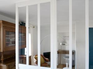 a white cabinet with a mirror in a room at Bel appartement avec vue directe sur loire in Saint-Paimboeuf