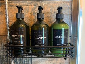 three bottles of wine sitting on a shelf at Coral Cabins in Dunvegan