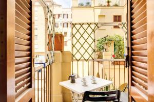 a table on a balcony with a view of a building at Apartment Colosseo in Rome