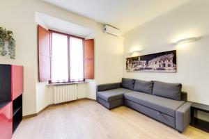 a living room with a couch and a window at Apartment Colosseo in Rome