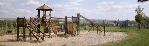 a playground with a slide in a park at Chalet im Spiel- und Obstgarten in Keidelheim