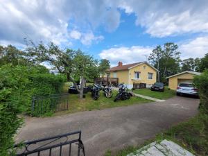 a house with two motorcycles parked in the driveway at lägenhet i Borgholms villa in Borgholm