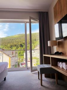 a bedroom with a large window with a view at Panorama ski, bike, spa & restaurant #328 in Sienna