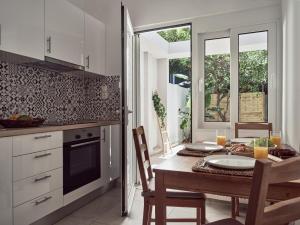 a kitchen with a table and a dining room at Margie City Apartment in Zakynthos
