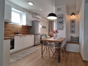 a kitchen with a table and chairs and a refrigerator at Marko's Apartment in Ohrid
