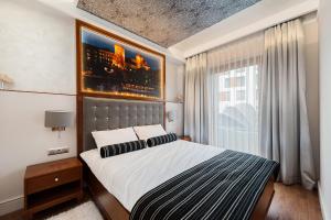 a bedroom with a large bed and a window at ApartmentPrestige Central Station in Kraków