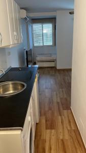 a kitchen with a sink and a counter top at Estudio cerca de la playa 3 in Málaga