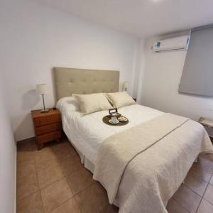 a bedroom with a bed with a white bedspread at L&B departamento premium céntrico II Jujuy in San Salvador de Jujuy +7 photos