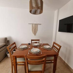 a wooden table with four chairs and a dining room at L&B departamento premium céntrico II Jujuy in San Salvador de Jujuy