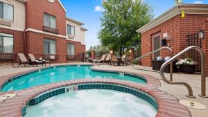 a swimming pool in front of a building at Best Western Plus Boulder Louisville in Louisville