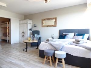 a bedroom with a large bed and a table at Mountain Suite Winterberg Ferienwohnung Pool Sauna Hund 4 Pers Wifi near Ski Lift in Winterberg +25 photos