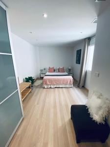 a bedroom with a bed and a couch at Fantastic Apartment City Center - Optional Parking in Málaga