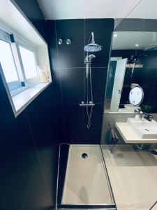 a bathroom with a shower and a sink at Fantastic Apartment City Center - Optional Parking in Málaga