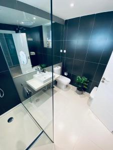 a bathroom with a shower and a sink and a toilet at Fantastic Apartment City Center - Optional Parking in Málaga