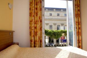 Säng eller sängar i ett rum på Hotel de L'Opéra