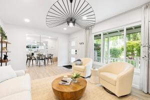 a living room with white furniture and a table at @ Marbella Lane - Charming and Modern Home in SJ in San Jose