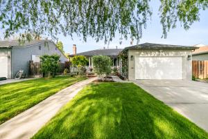 a yard with a house and a driveway at @ Marbella Lane - Charming and Modern Home in SJ in San Jose