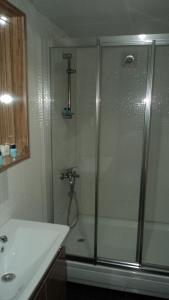 a shower with a glass door next to a sink at Kadikoy Bade 3 Hotel in Istanbul