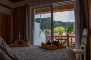 a bedroom with a bed with yellow shoes on it at Domus Nostra in Furnas