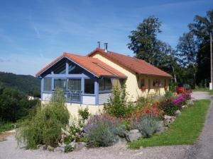 a small yellow house with a red roof at Gîte à la montagne avec cheminée, wifi et joli terrain - FR-1-589-179 in Le Tholy