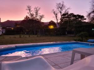 a swimming pool in a yard with a sunset at Casa San Lorenzo in San Lorenzo