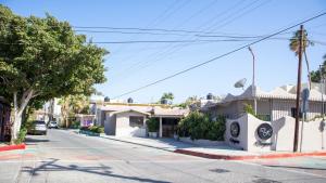 an empty street in a small town with buildings at Donjuan By Melida Hotel in Cabo San Lucas