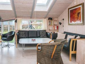 a living room with a couch and a table at 6 person holiday home in Sj lund in Sjølund