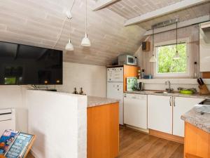 a kitchen with white cabinets and a counter top at 4 person holiday home in Ringk bing in Søndervig