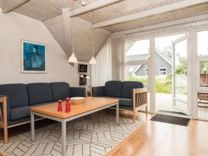 a living room with a couch and a table at 4 person holiday home in Ringk bing in Søndervig