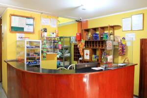 a counter in a store with yellow walls at HOSTAL JUMI in Tacna