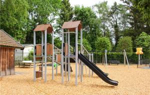 a playground with a slide in a park at Amazing Home In Epe With Kitchen in Epe