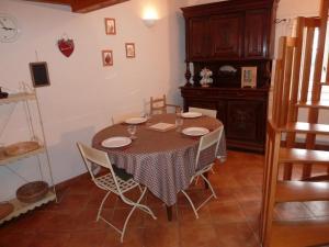 a dining room with a table and chairs at Charmant gîte avec poêle à bois, terrasse et jardin, sentiers rando, 1 chambre + mezzanine - FR-1-496-256 in Véranne +6 photos