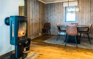 a wood stove in a room with a table at 2 Bedroom Nice Apartment In Oppdal in Oppdal