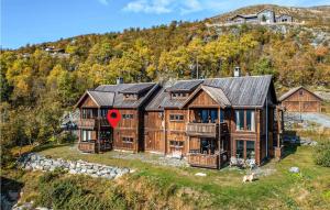 a large wooden house on top of a hill at 2 Bedroom Nice Apartment In Oppdal in Oppdal