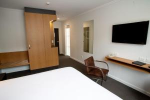 a hotel room with a television and a bed at expressotel in Napier