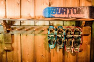 a snowboard is hanging on a wooden wall at Northern Nights Chalet by Wanderlust Abodes in Bellaire