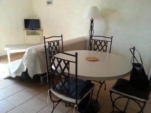 Una sala de estar con una mesa y sillas y un sofá. en Gordes Le Bastidon, en Gordes