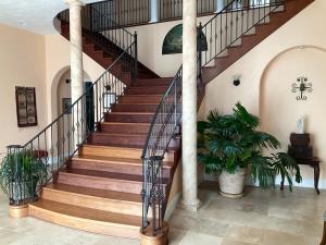 a spiral staircase in a house with aoyer with a plant at Lakeside Villa in Cottage Grove