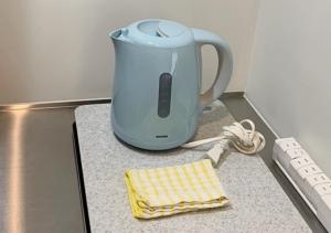 a blender sitting on a counter with a yellow towel at Cross Bridge Ikebukuro in Tokyo